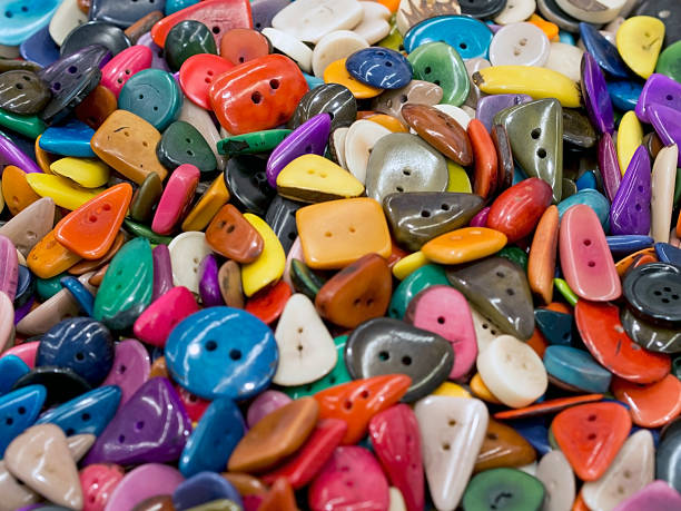 many  colored buttons of various shapes  on each other stock photo
