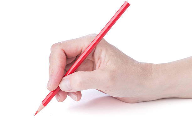istock female hand with a red pencil 473883198