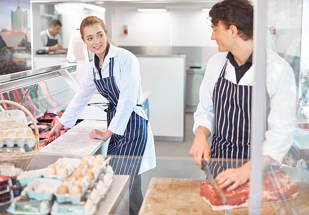 istock trainee butchers in a butcher's shop 473895246
