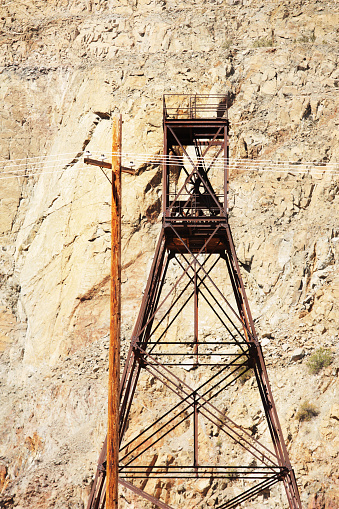 Abandoned mining Shaft Tower or Headframe - also called a Gallows Frame, Shafthead Frame, Pit Frame, or Poppethead - and wood telephone pole.  Jerome, Arizona, 2015.