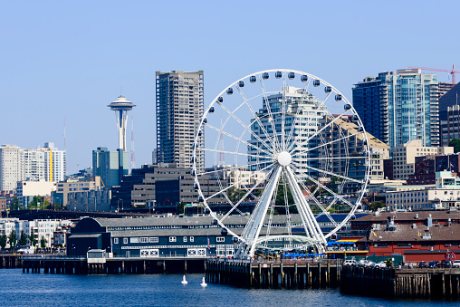 Ferris wheel at the Seattle pier with the Space Needle in the background. Washington State