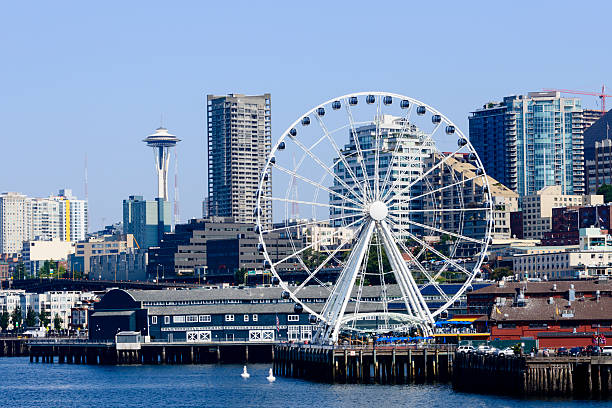 XXXL: Ferris wheel at the Seattle pier. Ferris wheel at the Seattle pier with the Space Needle in the background. Washington State seattle ferris wheel stock pictures, royalty-free photos & images