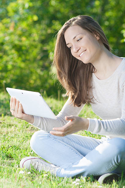 istock Young woman using digital tablet mobile in nature. 473906682
