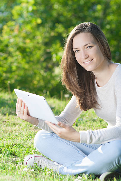 istock Young woman using digital tablet mobile outdoors. 473906710