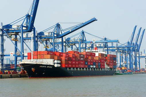 Ho Chi Minh City, Viet Nam - February 11, 2015: Transportation for export, import at Cat Lai port on Sai Gon river, crane load container to boat, this habour is big industry service for trade, Vietnam, Feb 11,2015