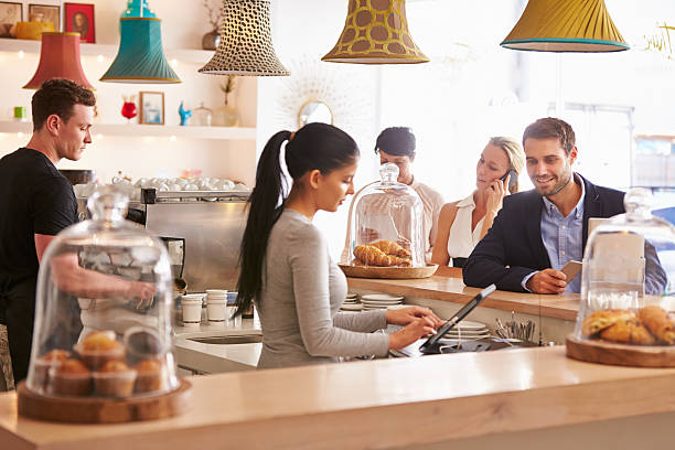 istock A businessman ordering at a counter in a cafe 473909142