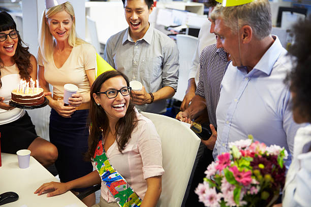 istock Birthday celebration at an office with cake and flowers 473909230