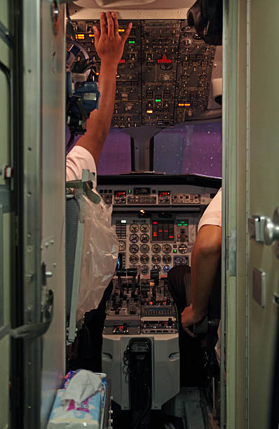 Chiang Mai, Thailand - June 15, 2013: Pilots stating up a Nok Air ATR-72 turbojet aircraft at the Chiang Mai International Airport.