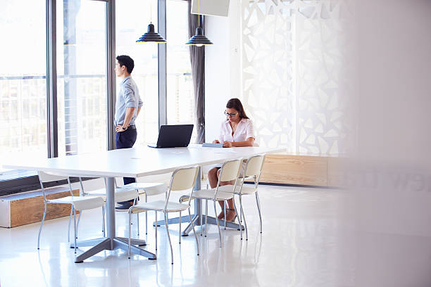 istock Two people working with digital tablet in empty meeting room 473909354