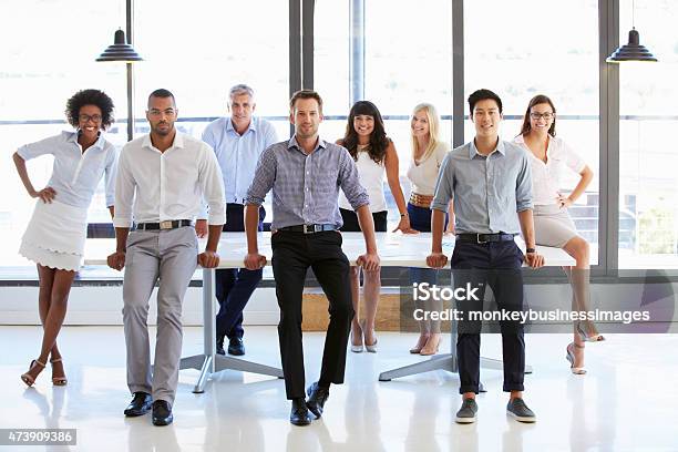 Colleghi In Posa A Macchina Fotografica In Sala Riunioni - Fotografie stock e altre immagini di Business casual