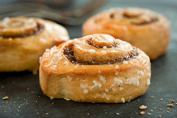 istock Close-up of a cinnamon bun with other buns in the background 473916062