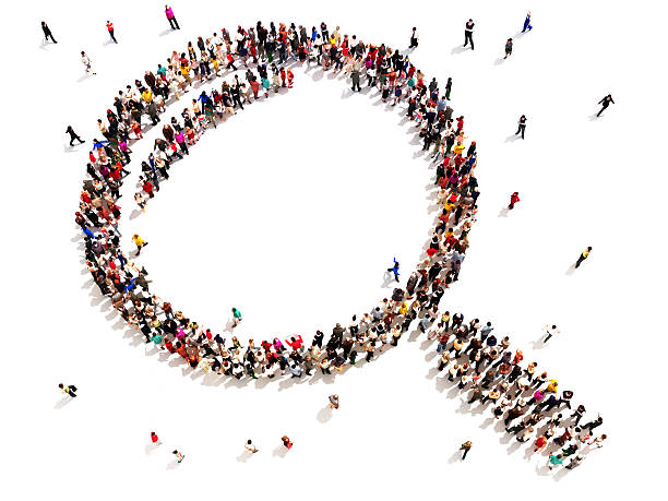 Large group of people in the shape of a magnifying glass. stock photo