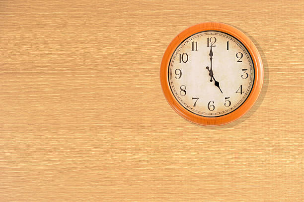 istock Clock showing 5 o'clock on a wooden wall 473919762