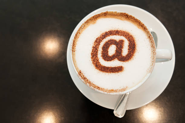 istock Cappuccino with @ Symbol on Froth in Coffee Cup 473923388