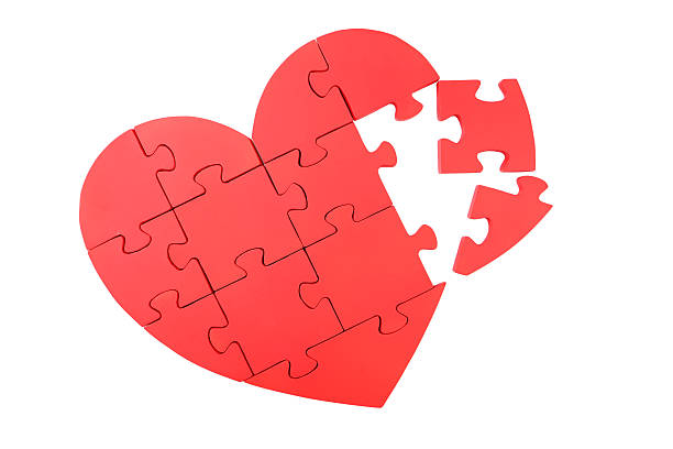 istock Red puzzle heart isolated on white 473923434
