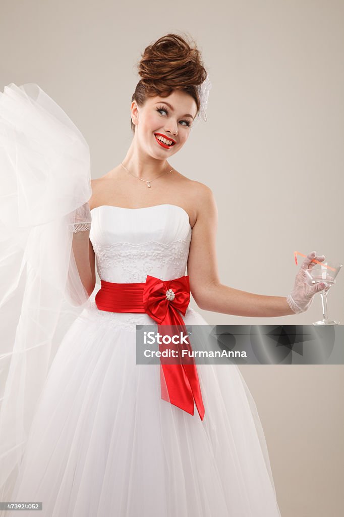 Excited Pin-up girl Excited Pin-up bride with glass of martini.Professional make-up, hair and style. 20-24 Years Stock Photo