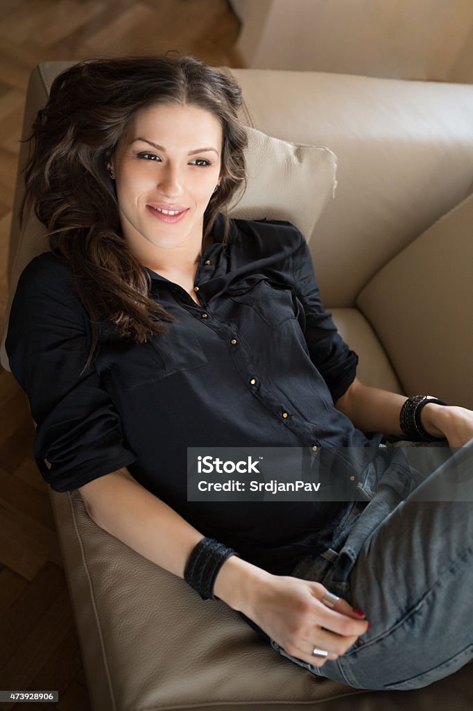 My Place Of Comfort Beautiful young woman lying on the sofa, enjoying her free time at home. 20-29 Years Stock Photo