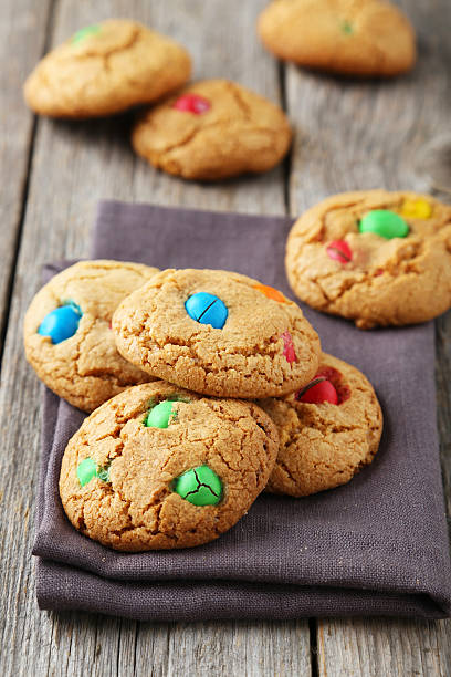istock Cookies with colorful candy on grey wooden background 473929566