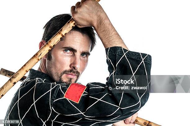 Martial Arts Master With Bamboo Sticks Stock Photo - Download Image Now - 2015, Activity, Adult