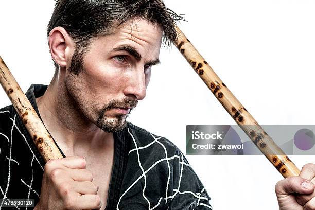 Martial Arts Master With Bamboo Sticks Stock Photo - Download Image Now - 2015, Activity, Adult