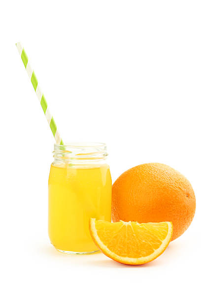 istock Orange juice in bottle isolated on white 473930162