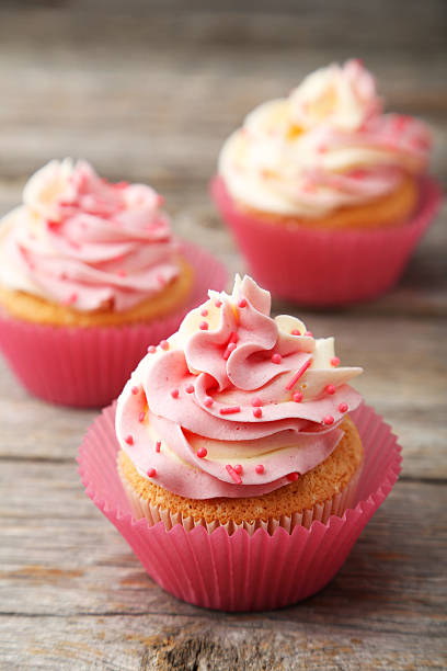 istock Tasty cupcake on grey wooden background 473932600