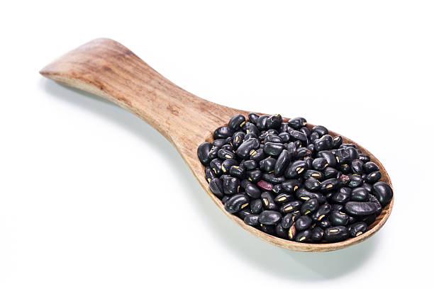 istock black beans in wooden spoon 473935650