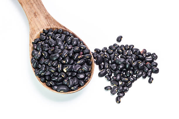istock black beans in wooden spoon 473936768