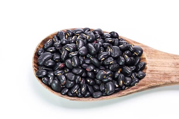 istock black beans in wooden spoon 473937450
