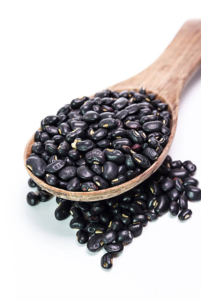 istock black beans in wooden spoon 473939614