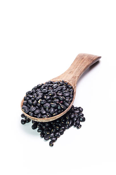 istock black beans in wooden spoon 473939620