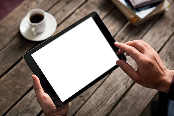 istock Man shows screen of tablet in his hands 473940428