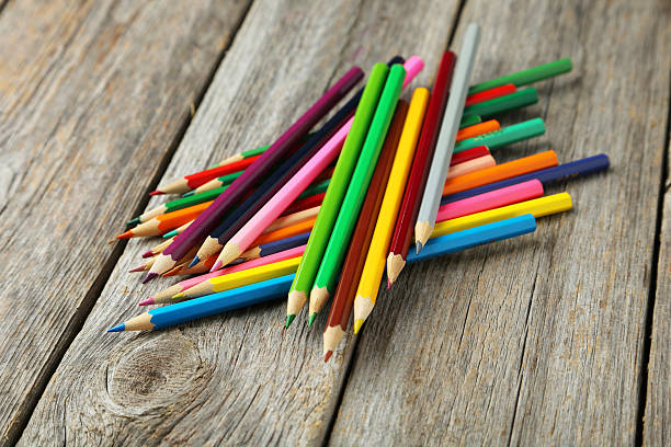 istock Colour pencils on grey wooden background 473940744