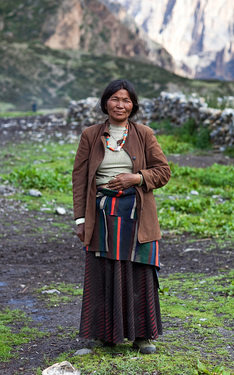 Shey, Nepal - September 4, 2011: Tibetan woman walking on the road to Shey Gompa in Dolpo.