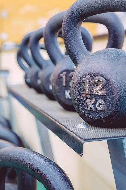 istock Kettlebells rows with different weights in fitness center 473947854