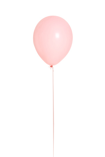 Isolated image of pastel pink helium Balloon with string attached rising up.