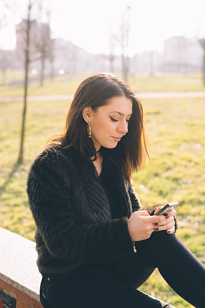 istock young beautiful woman using smartphone 473953784