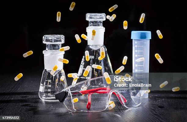 Composition Safety Glasses Chemical Glassware And Capsules Stock Photo - Download Image Now