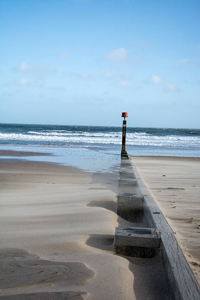 istock Sand blowing over groyne on beach, erosion, longshore drift 473957102
