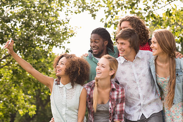 istock Happy friends in the park taking selfie 473957752