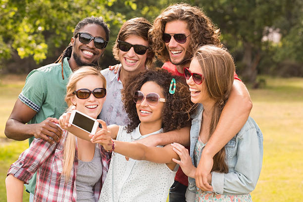istock Happy friends in the park taking selfie 473957808