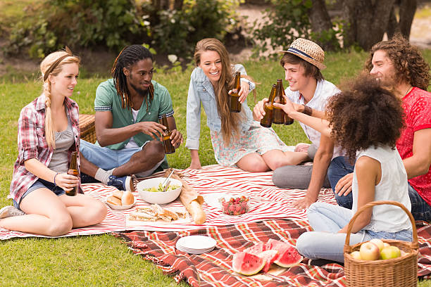 istock Happy friends in the park having picnic 473960590