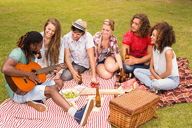 istock Happy friends in the park having picnic 473960610