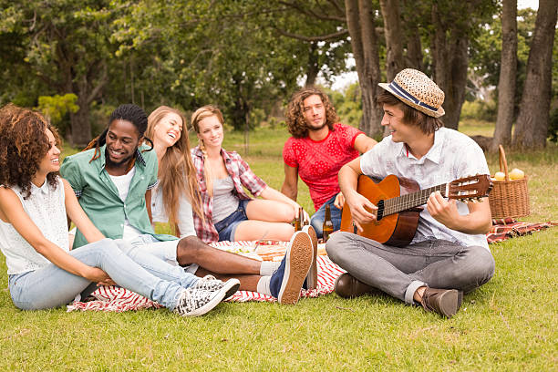 istock Happy friends in the park having picnic 473960618