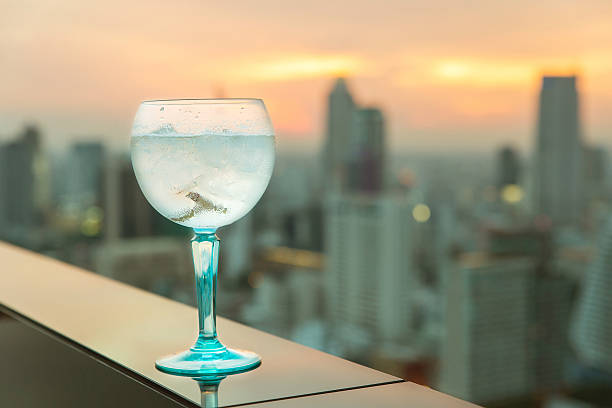 Gin tonic cocktail on table in rooftop bar