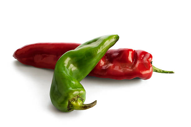 istock Green and red peppers isolated on white. 473964372