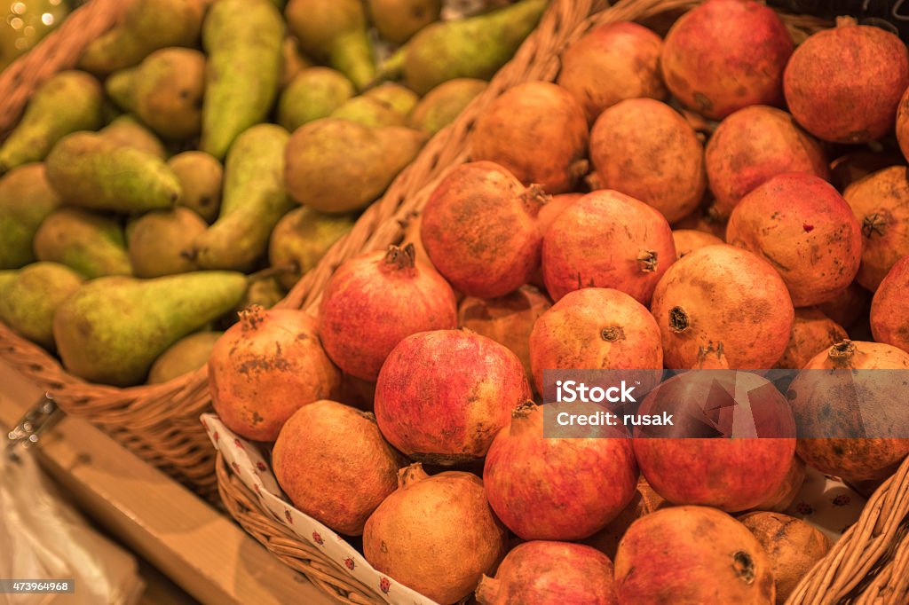 supermarket Counter with ripe pomegranates and pears in supermarket  2015 Stock Photo