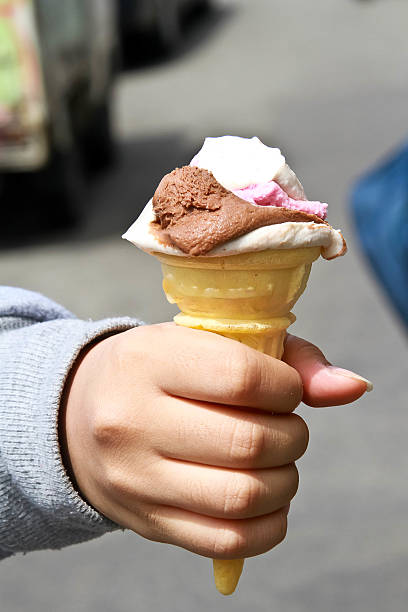 istock Ice cream inside young girl hand 473972150