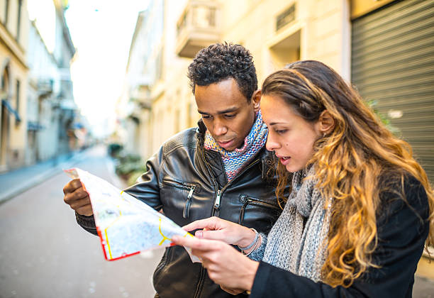istock Young couple with city map lost in Milan 473974522