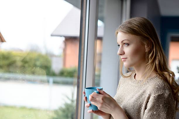 istock Beautiful  young blond woman drinking tea 473976410